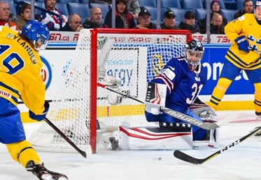 BUFFALO, NEW YORK - JANUARY 4: Sweden's Alexander Nylander #19 fires a shot at USA's Joseph Woll #31 during the semi-final round of the 2018 IIHF World Junior Championship. (Photo by Andrea Cardin/HHOF-IIHF Images)

